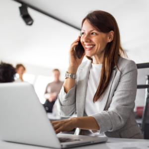 woman on phone while typing using Microsoft teams operator connect