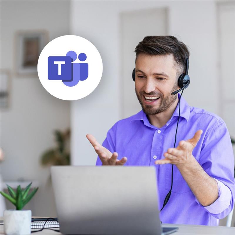 Man in a purple dress shirt chats on the computer while wearing a headset for Microsoft Teams