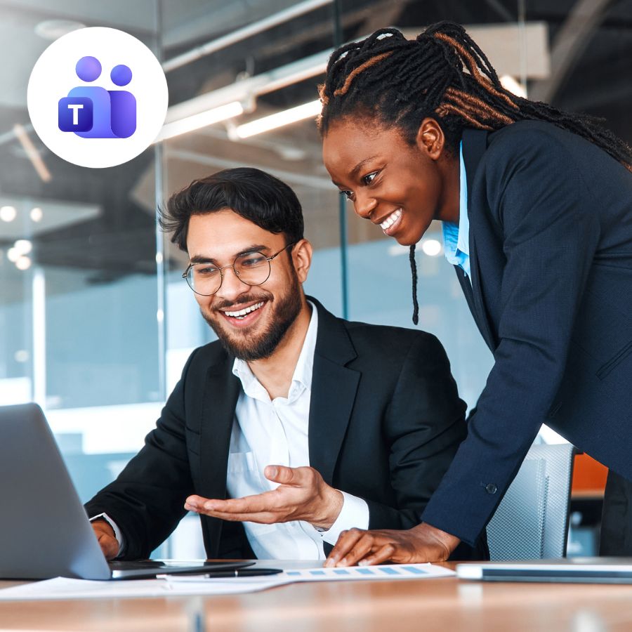 Two professionals in a modern office, smiling and collaborating on a laptop. A Microsoft Teams logo is visible, suggesting teamwork and communication.