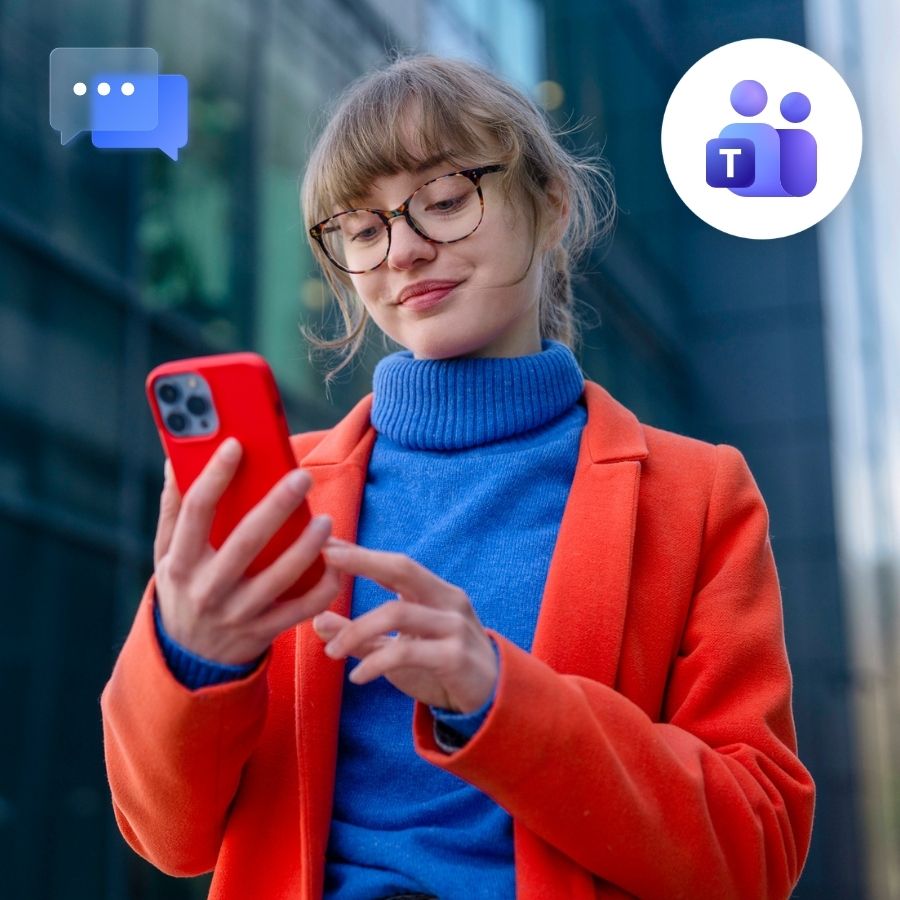 Woman in a red coat and blue turtleneck texting on a red phone downtown, Teams and chat icons.